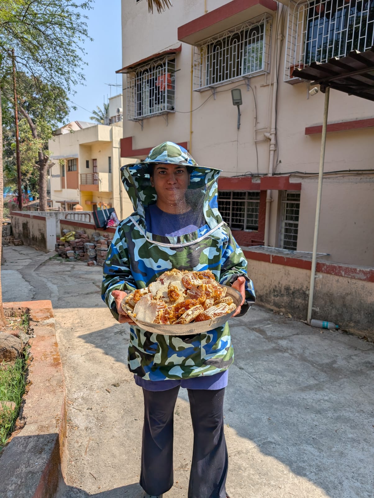 Professional beekeeper with honeycomb harvest